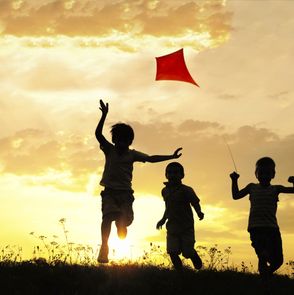 Children running with kite