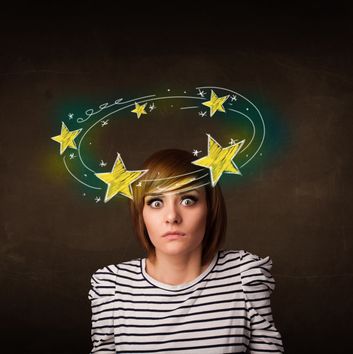 Young girl with yellow stars circleing around her head illustration